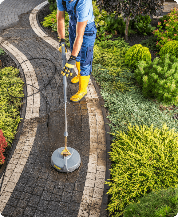 Jet washing a beautiful pathway in a garden